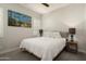 Cozy bedroom with a comfortable bed, side tables, and a striking piece of artwork at 21387 W Meadowbrook Ave, Buckeye, AZ 85396