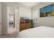 Bedroom with a view of a dresser, TV and a view into another room at 21387 W Meadowbrook Ave, Buckeye, AZ 85396