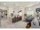 Open-concept kitchen features white cabinets, a large island with seating, and stylish pendant lighting at 21387 W Meadowbrook Ave, Buckeye, AZ 85396
