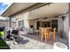 Inviting covered patio with wood furniture, bbq, and heaters, perfect for outdoor gatherings and relaxation at 21387 W Meadowbrook Ave, Buckeye, AZ 85396