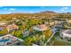 Captivating aerial view of a neighborhood with beautiful landscaping, swimming pools, and mountain views at 2174 E Avenida Del Valle Ct, Gilbert, AZ 85298
