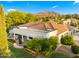 Stunning aerial view of a luxurious estate showcasing a well-manicured lawn, lush trees, and architectural beauty at 2174 E Avenida Del Valle Ct, Gilbert, AZ 85298