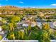 Expansive aerial view of a luxury home showcasing the private backyard, pool, and surrounding neighborhood with mountain views at 2174 E Avenida Del Valle Ct, Gilbert, AZ 85298