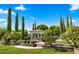 Lush backyard with a pool, spa, gazebo, manicured landscaping, and comfortable seating areas at 2174 E Avenida Del Valle Ct, Gilbert, AZ 85298