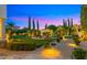 Expansive backyard features manicured lawns, garden beds, and an elegant pergola, creating a serene outdoor space at 2174 E Avenida Del Valle Ct, Gilbert, AZ 85298