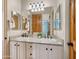 Modern bathroom with double sinks, granite countertops, and wooden accents, providing a functional and stylish space at 2174 E Avenida Del Valle Ct, Gilbert, AZ 85298