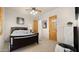 Cozy bedroom with a dark wood bed frame, soft carpet, and a decorative fan, creating a relaxing ambiance at 2174 E Avenida Del Valle Ct, Gilbert, AZ 85298