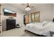 Bright bedroom with a large television and dark wood furniture, offering a comfortable and modern living space at 2174 E Avenida Del Valle Ct, Gilbert, AZ 85298