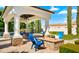 Relaxing backyard cabana with outdoor seating and stone fire pit, perfect for entertaining guests and enjoying outdoor living at 2174 E Avenida Del Valle Ct, Gilbert, AZ 85298