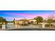 Stunning exterior elevation of a home with a circular driveway and meticulously landscaped grounds at 2174 E Avenida Del Valle Ct, Gilbert, AZ 85298