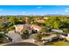 Elegant home with a circular driveway, mature landscaping, and a tile roof at 2174 E Avenida Del Valle Ct, Gilbert, AZ 85298