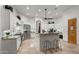 Bright kitchen featuring white cabinets, granite countertops, stainless steel appliances, and a breakfast bar at 2174 E Avenida Del Valle Ct, Gilbert, AZ 85298