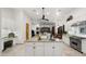 Bright kitchen with granite counters, stainless steel appliances, and an open floorplan into the living area at 2174 E Avenida Del Valle Ct, Gilbert, AZ 85298