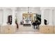 Bright living room with decorative pillars, natural light and a grand piano making for an elegant and musical space at 2174 E Avenida Del Valle Ct, Gilbert, AZ 85298
