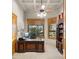 Sophisticated home office with custom wooden desk, built-in shelving, and bright natural light, perfect for productivity at 2174 E Avenida Del Valle Ct, Gilbert, AZ 85298