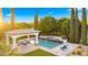 Inviting pool and spa area with a covered patio, seating, and meticulously maintained landscaping at 2174 E Avenida Del Valle Ct, Gilbert, AZ 85298