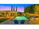 Luxurious pool area featuring a covered pergola, elegant landscaping, and comfortable lounge chairs, creating a relaxing oasis at 2174 E Avenida Del Valle Ct, Gilbert, AZ 85298