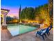 Beautiful backyard with a sparkling pool featuring a tiled waterfall and inviting lounge chairs for poolside relaxation at 2174 E Avenida Del Valle Ct, Gilbert, AZ 85298