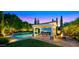Covered patio beside a pool, hot tub, outdoor dining and bar area with seating and manicured landscaping at 2174 E Avenida Del Valle Ct, Gilbert, AZ 85298
