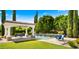 Pool and spa area with a covered patio, elegant landscaping, and a serene waterfall feature at 2174 E Avenida Del Valle Ct, Gilbert, AZ 85298