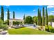 Relaxing pool area with a covered patio, stylish seating, and beautiful landscaping creating a perfect outdoor retreat at 2174 E Avenida Del Valle Ct, Gilbert, AZ 85298
