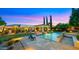 Beautifully landscaped pool area with comfortable seating, elegant lighting, and lush greenery for relaxation at 2174 E Avenida Del Valle Ct, Gilbert, AZ 85298