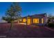 Night view of backyard featuring covered patio, desert landscaping, and privacy at 21913 N Pedregosa Ct, Sun City West, AZ 85375