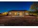 Night view of backyard featuring covered patio, privacy, desert landscaping and lighting at 21913 N Pedregosa Ct, Sun City West, AZ 85375