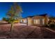 Night view of backyard featuring covered patio, desert landscaping, and privacy at 21913 N Pedregosa Ct, Sun City West, AZ 85375