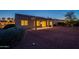 Night view of backyard featuring covered patio, privacy, desert landscaping and lighting at 21913 N Pedregosa Ct, Sun City West, AZ 85375