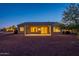 Night view of backyard featuring covered patio, privacy, desert landscaping and lighting at 21913 N Pedregosa Ct, Sun City West, AZ 85375