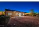 Night view of backyard featuring covered patio, privacy, desert landscaping and lighting at 21913 N Pedregosa Ct, Sun City West, AZ 85375
