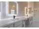 Elegant bathroom featuring dual sinks, marble countertops, and modern fixtures and hardware at 21913 N Pedregosa Ct, Sun City West, AZ 85375