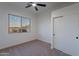 Bedroom with carpet flooring, closet, and large window at 21913 N Pedregosa Ct, Sun City West, AZ 85375