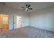 Large bedroom with carpet, a ceiling fan, and bathroom access at 21913 N Pedregosa Ct, Sun City West, AZ 85375