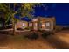 Night view of front exterior with desert landscaping and stone pillar accents at 21913 N Pedregosa Ct, Sun City West, AZ 85375