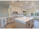 Bright, modern kitchen featuring white cabinetry, quartz counters, stylish backsplash, and an island at 21913 N Pedregosa Ct, Sun City West, AZ 85375