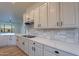 Close-up of kitchen with quartz countertops, stainless steel appliances, and white cabinetry at 21913 N Pedregosa Ct, Sun City West, AZ 85375