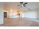 Open-concept living area showcasing sleek flooring, neutral walls, and seamless transition to the kitchen at 21913 N Pedregosa Ct, Sun City West, AZ 85375