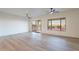 Bright living room featuring sleek flooring, modern ceiling fans, and sliding doors to the backyard at 21913 N Pedregosa Ct, Sun City West, AZ 85375