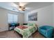 This bedroom features a ceiling fan, an armchair, a bed, and a desk with chair at 23306 S 221St St, Queen Creek, AZ 85142