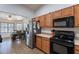 Functional kitchen with stainless steel appliances and warm cabinets, adjacent to the dining area at 23306 S 221St St, Queen Creek, AZ 85142