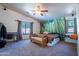 This main bedroom features a ceiling fan, wall decor, and a large window to let in sunlight at 23306 S 221St St, Queen Creek, AZ 85142