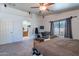 This main bedroom features a ceiling fan, natural light, and carpeted floors at 23306 S 221St St, Queen Creek, AZ 85142