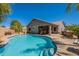 Backyard pool with covered patio and outdoor kitchen features, perfect for entertaining at 23306 S 221St St, Queen Creek, AZ 85142