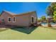 Backyard putting green with home exterior and mature trees in the background at 23306 S 221St St, Queen Creek, AZ 85142