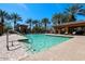 Inviting community pool featuring clear blue water, lounge chairs, and shade structures at 2580 E Boston St, Gilbert, AZ 85295