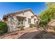 Side view of a well-kept beige single-story home featuring mature landscaping at 2580 E Boston St, Gilbert, AZ 85295