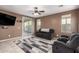 Relaxing living room with tile floors, ceiling fan, and sliding glass door to the patio at 2580 E Boston St, Gilbert, AZ 85295