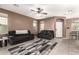 Comfortable living room with tile flooring, a ceiling fan, and neutral wall paint at 2580 E Boston St, Gilbert, AZ 85295